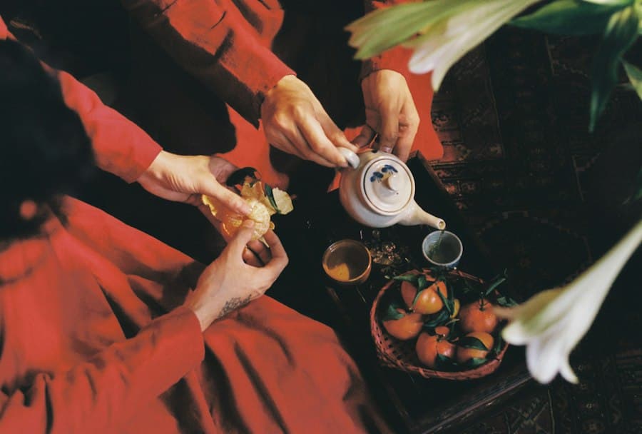 Ginger and dried fruit beside a warm cup