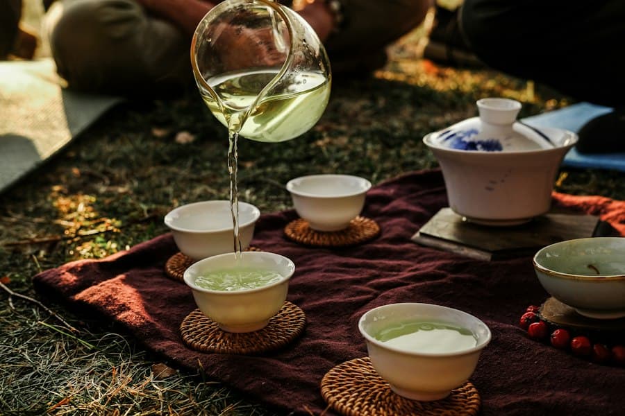 A gaiwan being poured, steam rising over a dark table