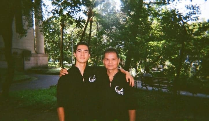 Ethan Holtzman standing together with his tai chi master