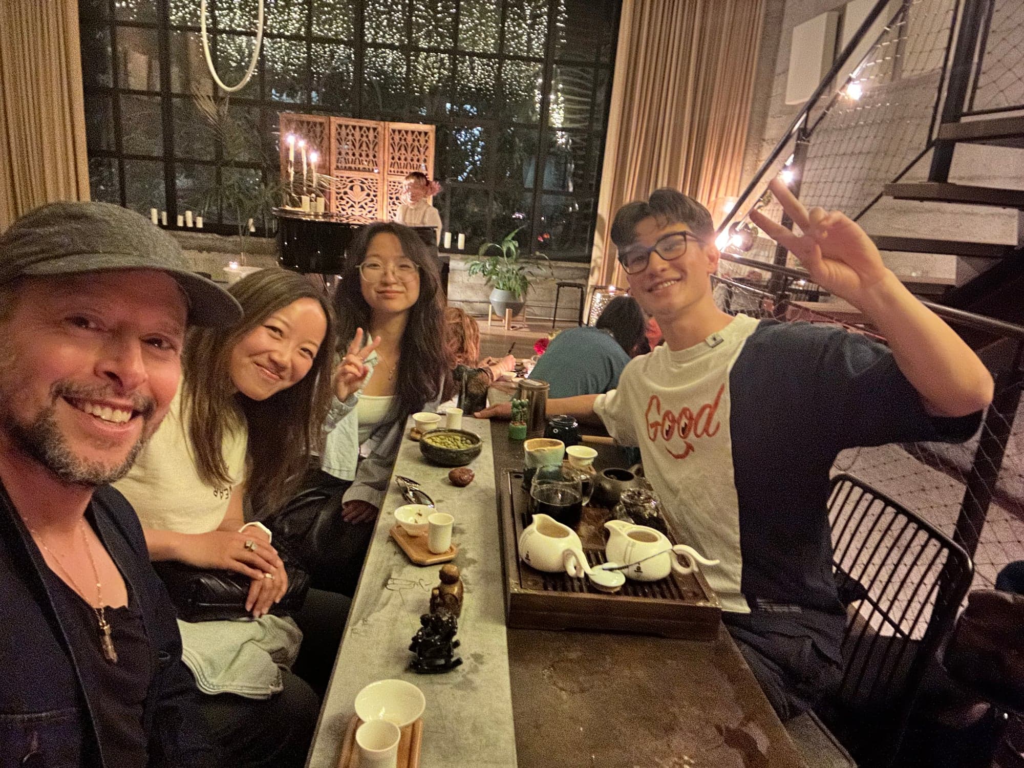 A group of friends smiling together during a tea tasting